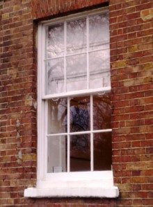 A sliding sash window recessed behind 4 inches of brickwork